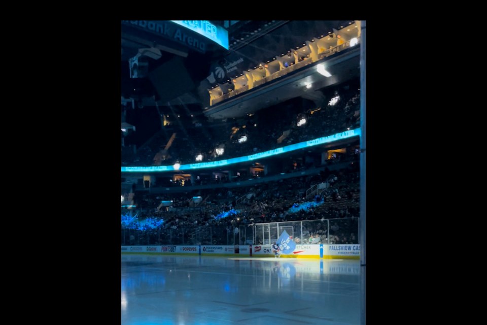 Felix Van Beek waves the Leafs' flag during recent pre-game ceremony.