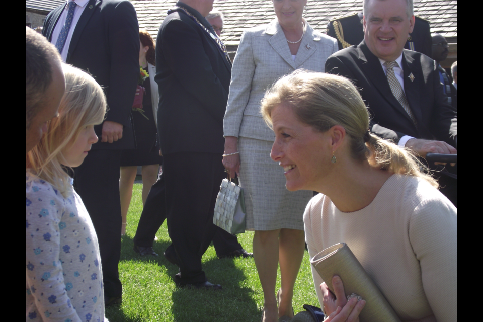 Former Ontario lieutenant-governor  David Onley, right, looks on as watches Sophie, Countess of Wessex, chats to a young girl during a visit to Sainte-Marie among the Hurons in 2012.