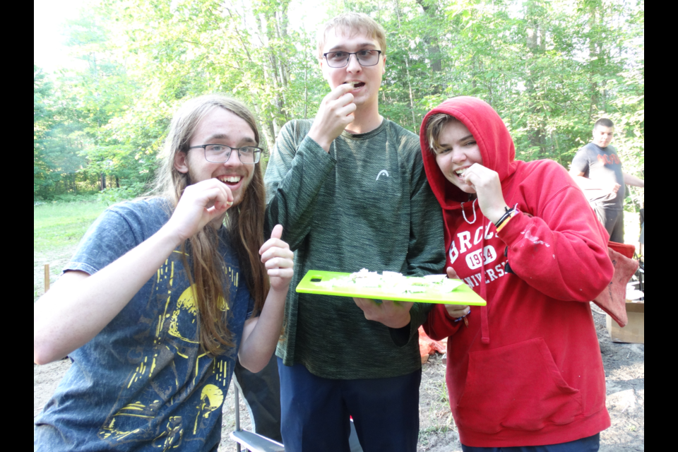 Jacob Clarke, Ethan Stevenson and Madyson Birch enjoy some Danish blue cheese.