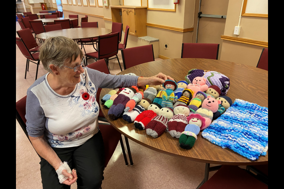 Holding up an Izzy doll makes it seem all that much more precious for Toni Reynolds. Izzy dolls are packed in humanitarian kits and then provided to local children all over the world. 