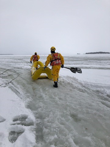Police provided photo shows the rescue of four snomobilers who's sleds became mired in slush or went into open water in Georgian Bay just off the point on Beausoleil Island.