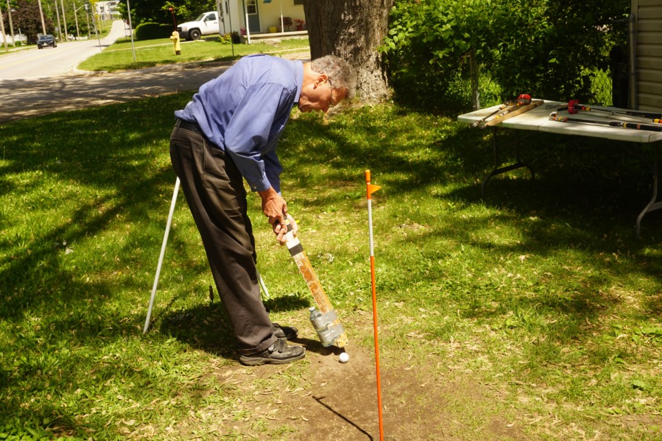 Donavon Quackenbush demonstrates his putting training aid system to improve accuracy for individuals who are having difficulty sinking golf putts on the golf course.