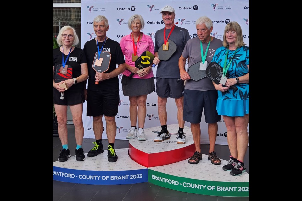 The Midland Area Pickleball Club won gold at the Ontario 55+ Summer Games in mixed doubles 65-plus pickleball with Kathy Wolfer and Brian Meisner, centre.