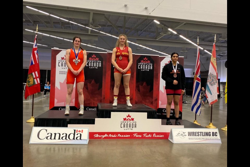 Lauren Smith stands atop the podium after capturing the gold medal at national wrestling championships in Vancouver.