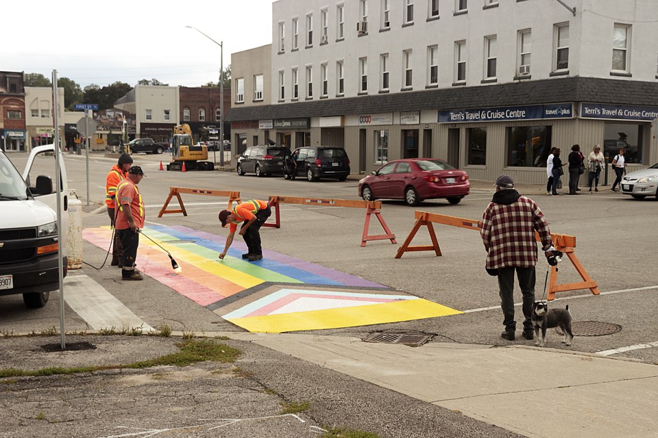 Most of an inclusive rainbow crosswalk was installed at Bay Street and First Street in Midland on Saturday; road crew stated the remainder would be installed by Monday.