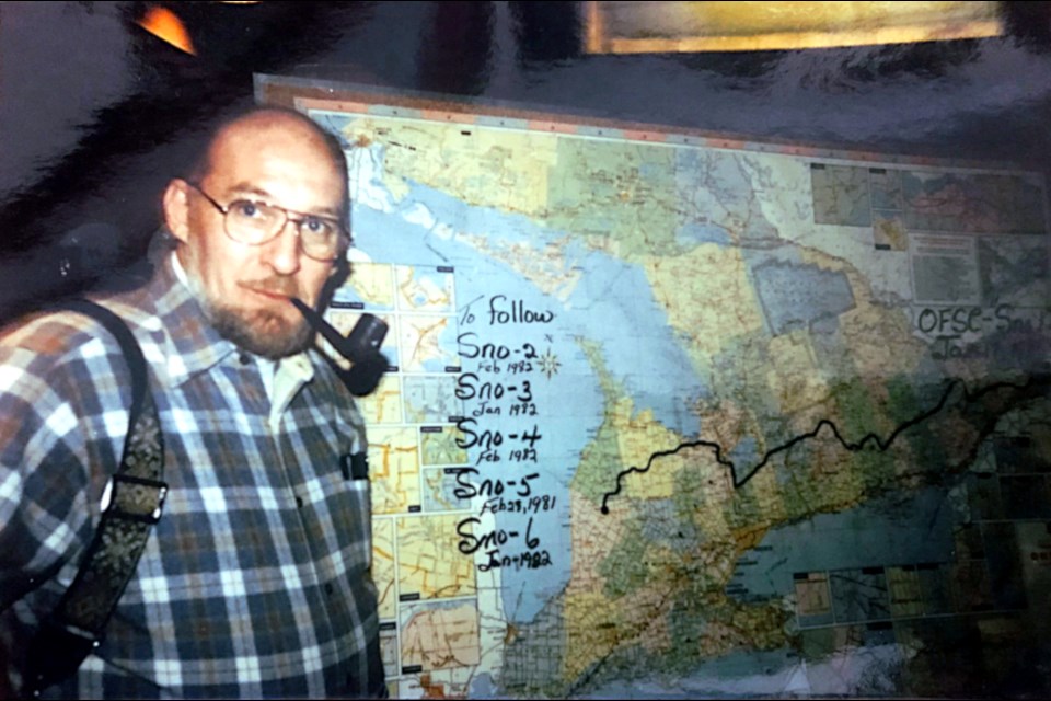Ontario Federation of Snowmobile Clubs founder John Power of Midland was seen in this historic photo from the early 1980s next to a map of trails across the province.