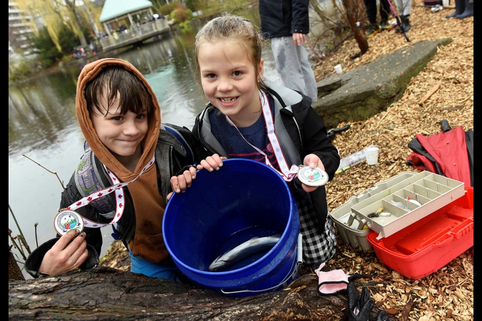 Nine-year-old Clark Jacobsen helps sister Violet, 6, show the rainbow trout she caught at the 35th annual Milton Kids Fishing Derby Saturday morning, which drew hundreds of young anglers and their parents to Mill Pond. The event was once again put on by the Halton Sportsmen's Association and supported by a number of local businesses.