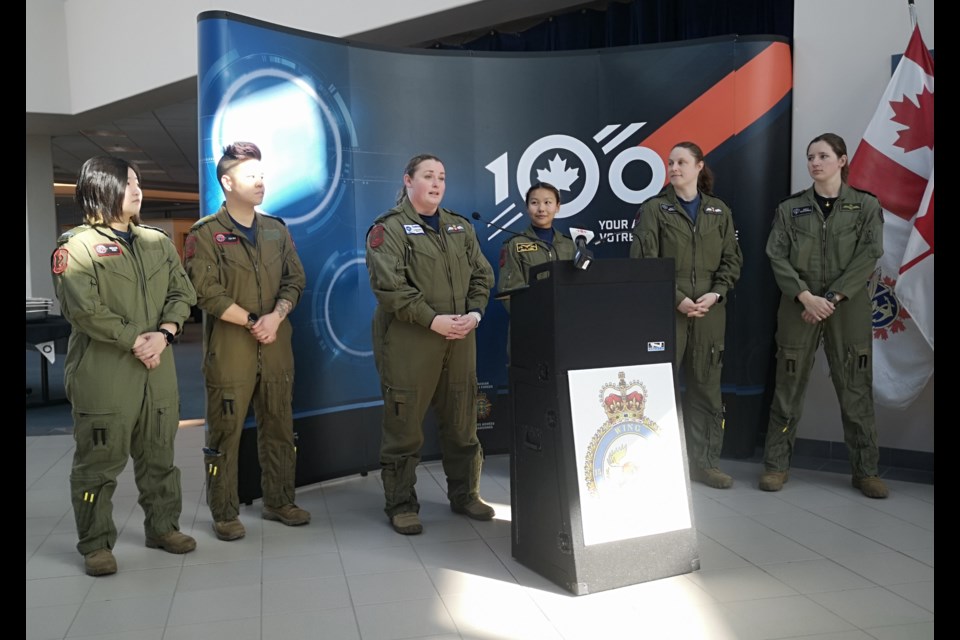 “You can do whatever you put your mind to,” said Major Amanda Maki (at podium) who spoke on behalf of the female pilots (present) who performed the March 8 flyby at 15 Wing.