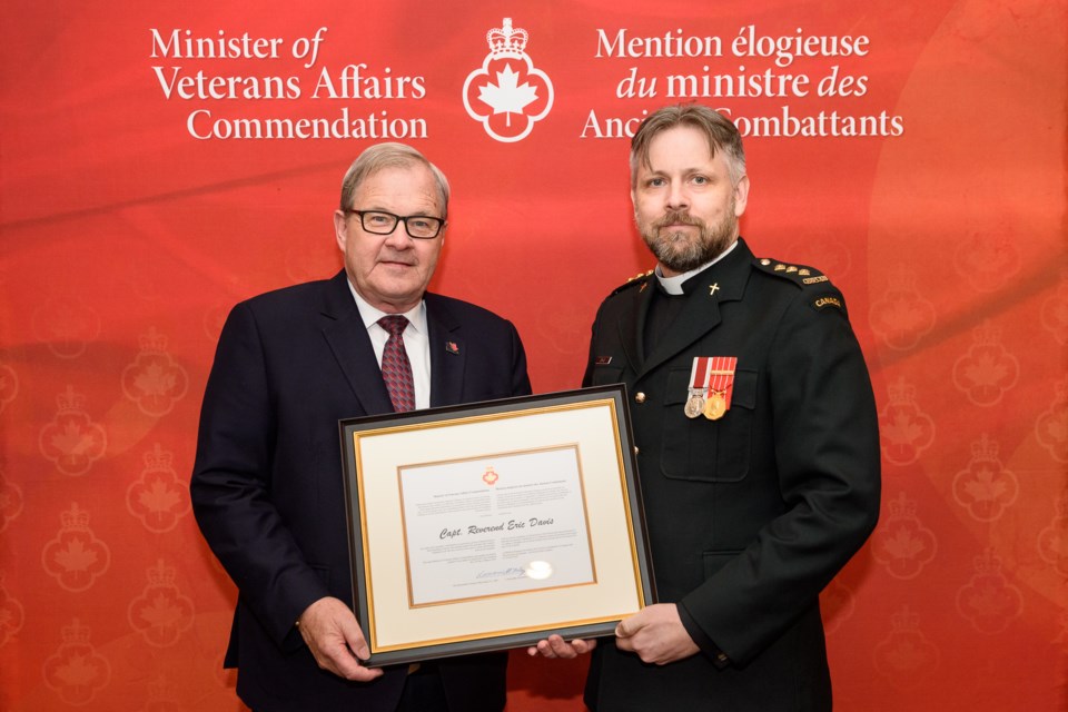 Veterans Affairs Minister Lawrence MacAulay presents Capt. Rev. Eric Davis with the Minister of Veterans Affairs Commendation Award, for his work in promoting sound mental health among serving members and veterans, during a recent ceremony in Richmond, British Columbia. 
