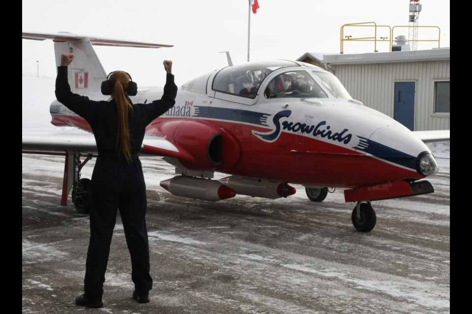 A Snowbirds jet slowly comes to a stop after taxiing to Hangar 7 with the Grey Cup trophy. Photo by Jason G. Antonio