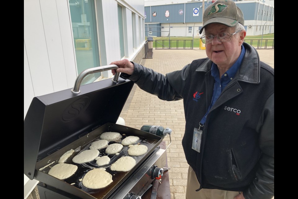 Volunteer Jim Worrall with base contractor Serco helps cook the pancakes. Photo by Jason G. Antonio 