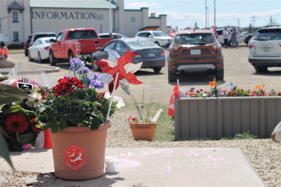 A socially distant crowd of Moose Jaw residents gathered out at Tourism Moose Jaw, the location of the current memorial flowers for Captain Jennifer Casey and Captain Richard MacDougall, to form a heart out of vehicles. (photo by Larissa Kurz)