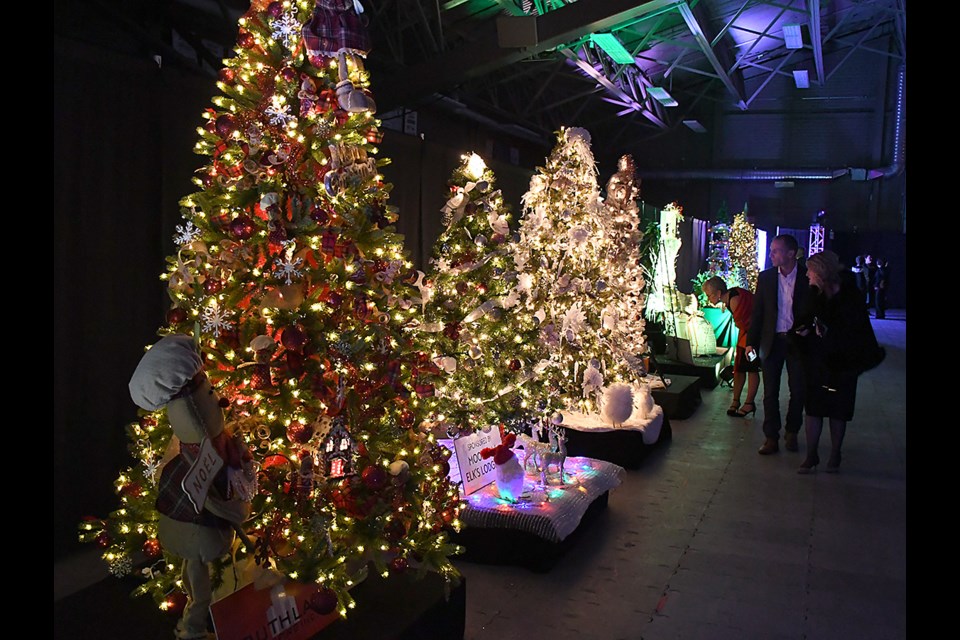 Patrons check out some of the impressively decorated trees on display.