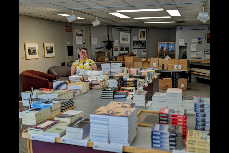 Amanda Farnel, executive director of the Saskatchewan Festival of Words, stands in the festival's temporary bookstore in the basement of the Moose Jaw Museum & Art Gallery