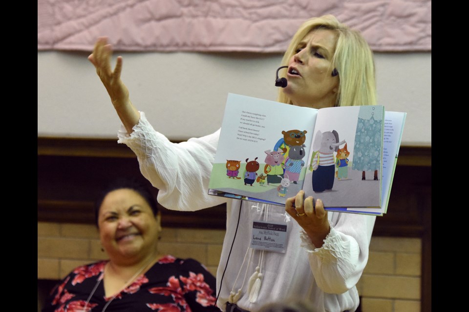 Lana Button reads from her children’s book My Teacher’s Not Here! as fellow author Eden Robinson shares a laugh in the background.