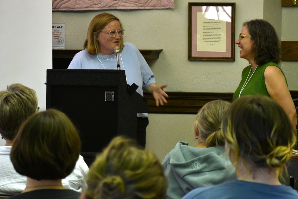 Meredith Hambrock (left) and K.J. Aiello (right) share the podium during an afternoon reading session on July 18 at the Moose Jaw Public Library. The pair spoke candidly about writing through anger, trauma, and the challenges of revising emotionally charged material.