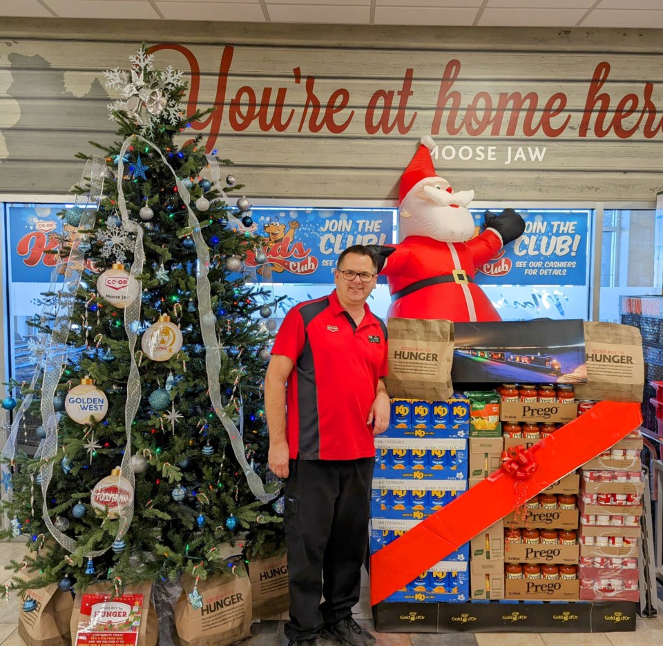 tim-wonsiak-grocery-manager-at-the-moose-jaw-co-op-food-store-with-a-pallet-of-food-destined-for-the-moose-jaw-food-bank