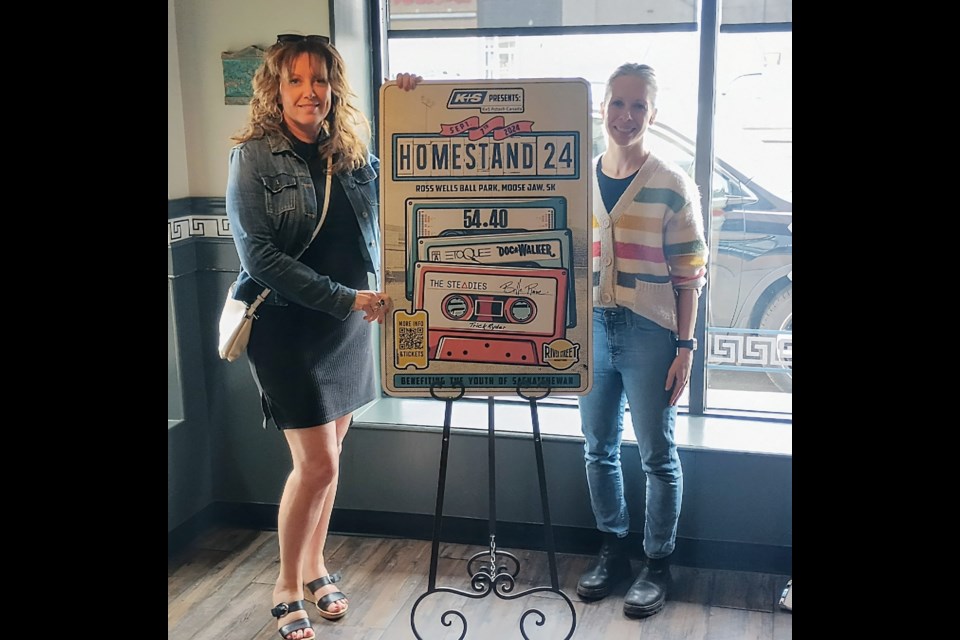 Laurie Kosior (left) stands next to Jocelyn Froehlich (right) who created the Homestand '24 poster design. 