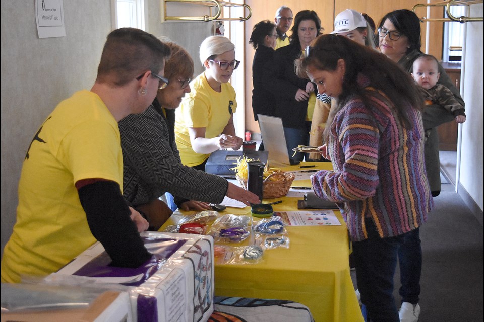 Journey to Hope volunteers show off some of their fundraising wares.