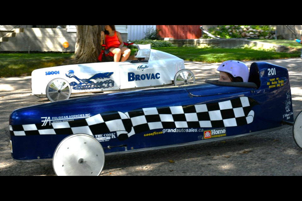Moose Jaw’s Octavia Penney (car No. 201) races side by side with Swift Current’s Kaylee Harlos (car No. 01) during a head-to-head heat at the Moose Jaw & District Soapbox Derby on Aug. 17.