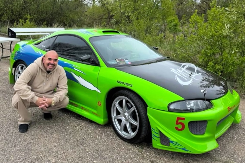 Actor Noel Gugliemi, best known for his role as Hector in The Fast and the Furious, poses next to a replica of Paul Walker’s iconic green Eclipse at the 2025 Next Gen Car Club season opener in Moose Jaw.