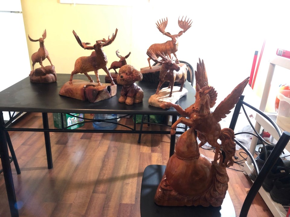 Son Ninh's wood carvings. He says that before he came to Canada, the moose represented the beautiful spirit of the country in his imagination