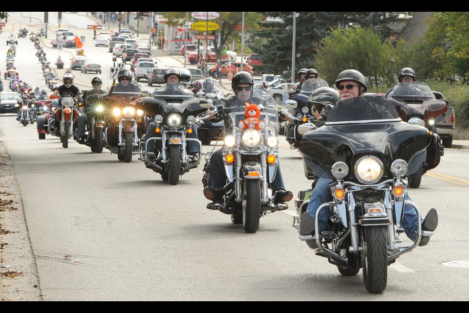 Participants in the 2019 Salvation Army Toy Run roll up Main Street.