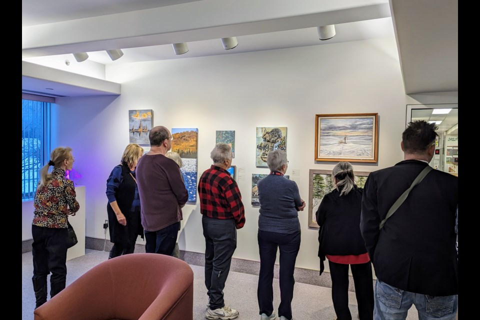 Guests take in the artworks at the 56th annual Moose Jaw Art Guild exhibition at the MJMAG