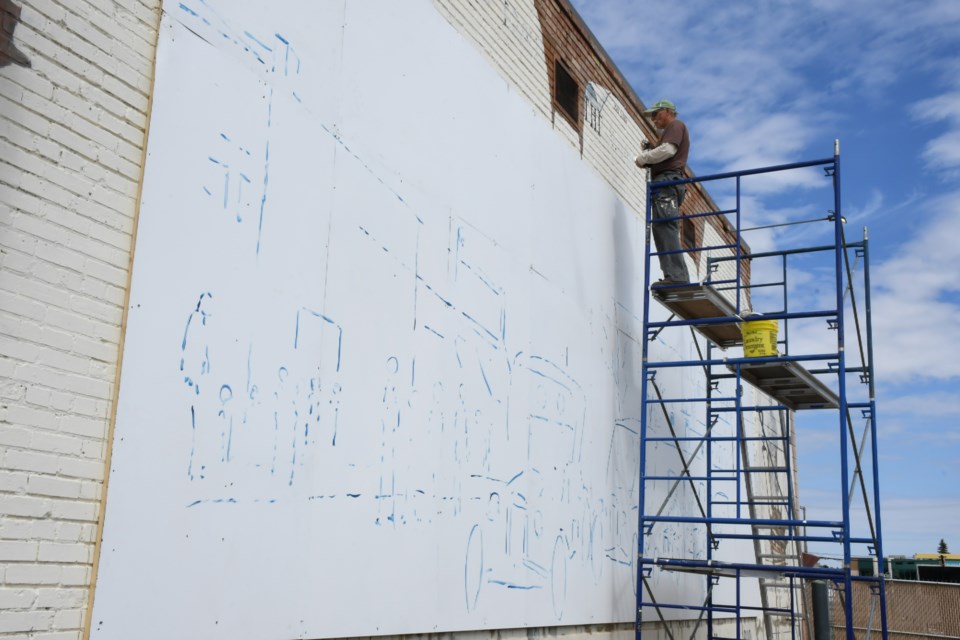 After attaching wood panelling to the wall, artist Grant McLaughlin sketched out what the picture looked like. Photo by Jason G. Antonio