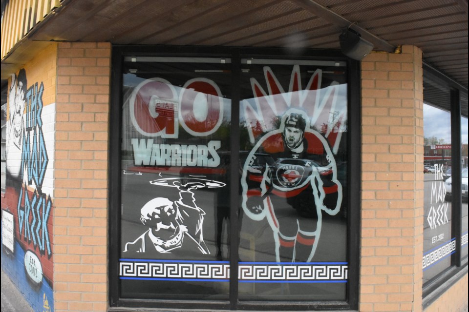 Carly Jaye’s painting of Denton Mateychuk on the Mad Greek window