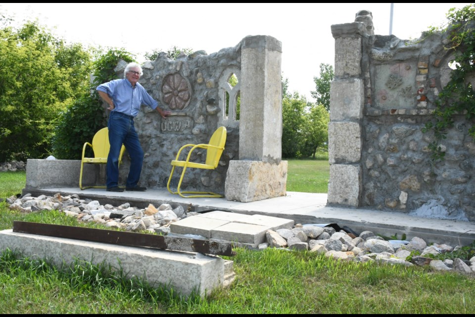Artist Jerry Kaiser poses with his monument that he built to honour early pioneer women in the Rural Municipality of Baildon. The RM forced him to take off a piece (foreground) to comply with size issues. Now he wants to reconnect the piece and is appealing to the courts for help. Photo by Jason G. Antonio 