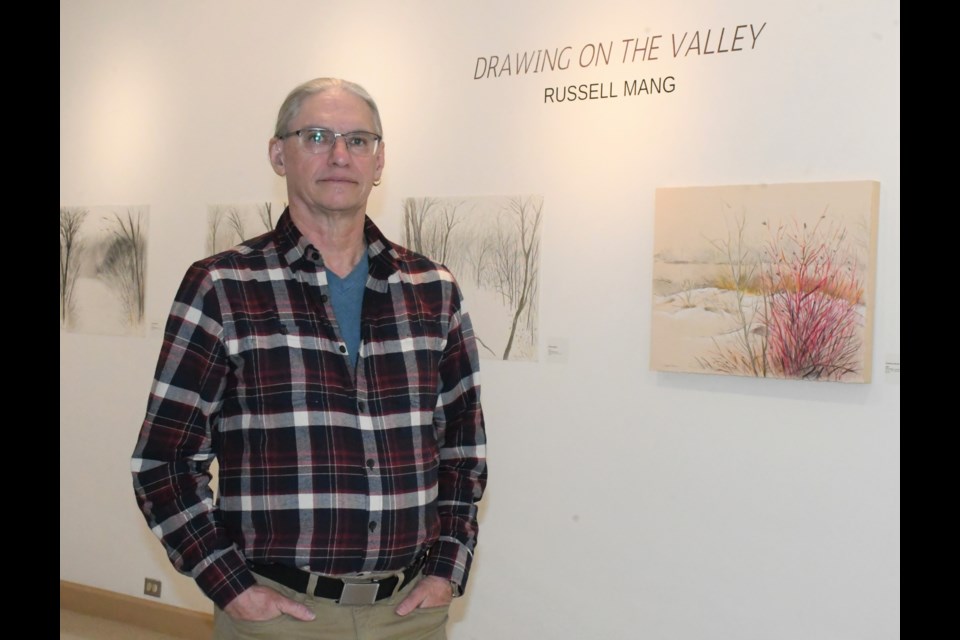 Artist Russell Mang stands in the art gallery at the Cultural Centre where his newest exhibit is being featured. Photo by Jason G. Antonio 