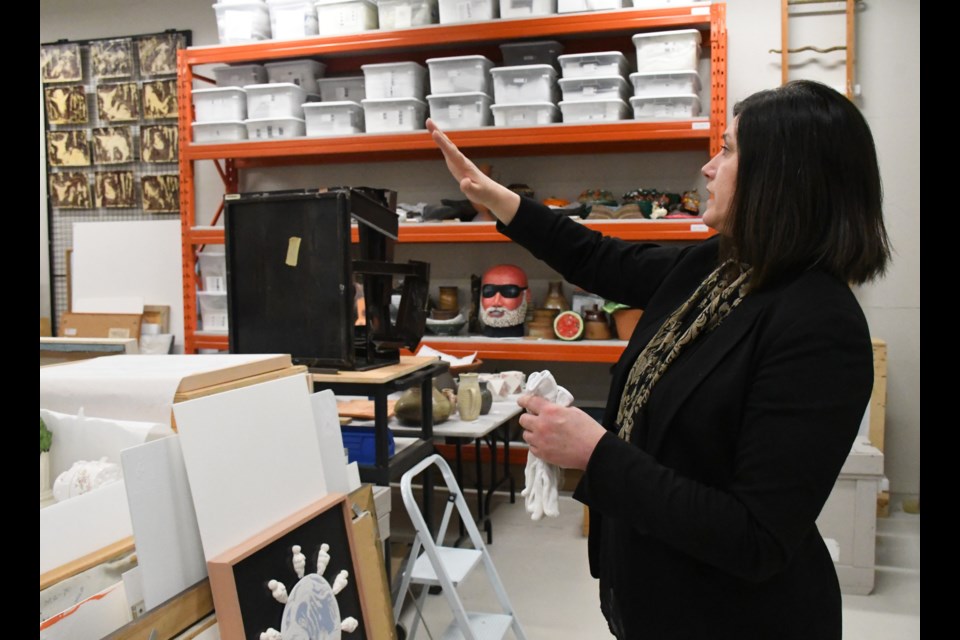 Jennifer McRorie, curator/director of the MJMAG, gives a tour of one of the two vaults. Photo by Jason G. Antonio