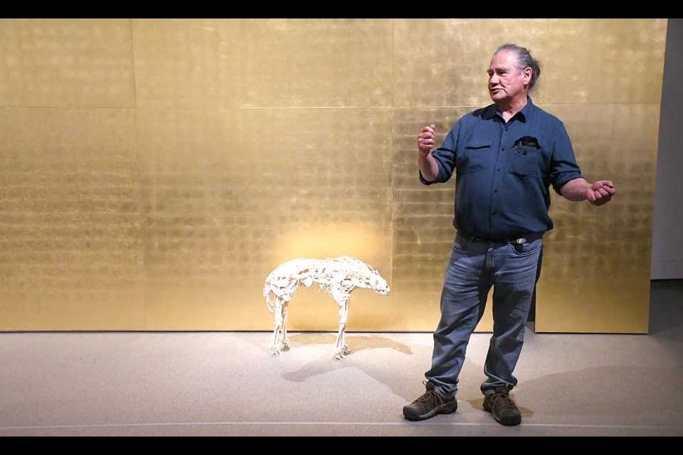 Indigenous artist Edward Poitras speaks in front of his massive piece 'Gold Wall' during his special presentation to officially open 'Revolution in the Rock Garden: A Treaty Four Art Action' at the Moose Jaw Museum and Art Gallery on Saturday afternoon.