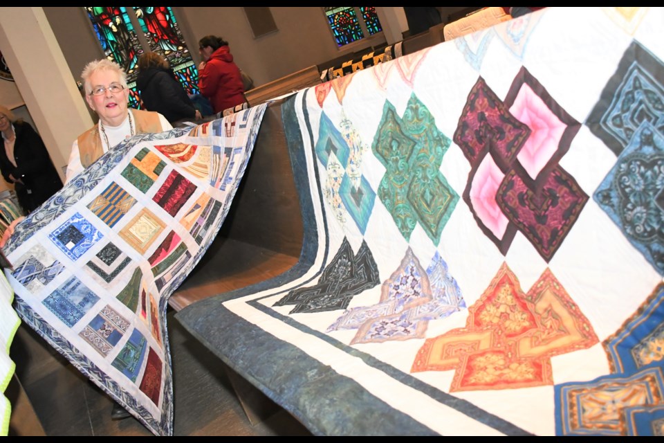 Karen Mundt with KJ Quilters shows off a couple of quilts she had on display during the quilt show. All photos by Jason G. Antonio 