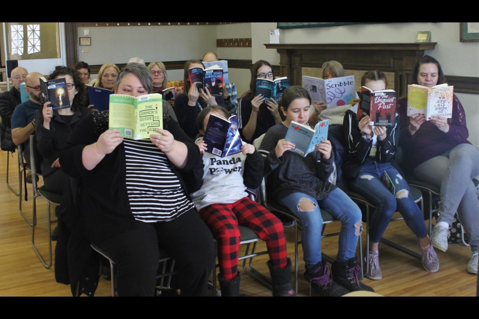 Those present for the Moose Jaw Public Library’s celebration of I Read Canadian Day took a moment to open one of the many Canadian books available from the library. 