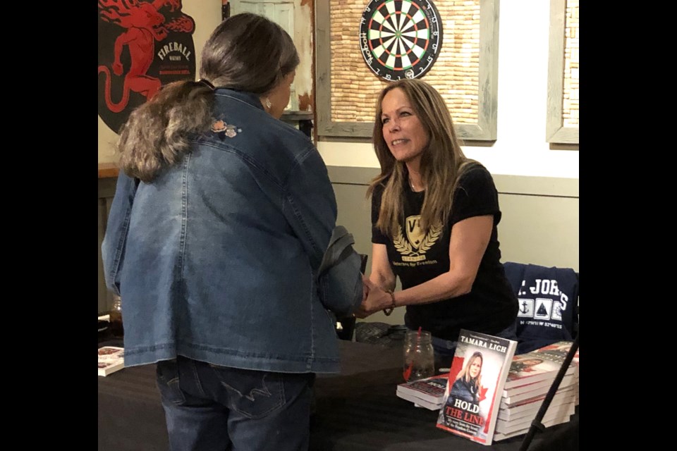 Tamara Lich (right), one of the co-organizers of the Freedom Convoy, meets supporters during a book signing and reading event at Cask 82 on April 23. Photo by Jason G. Antonio