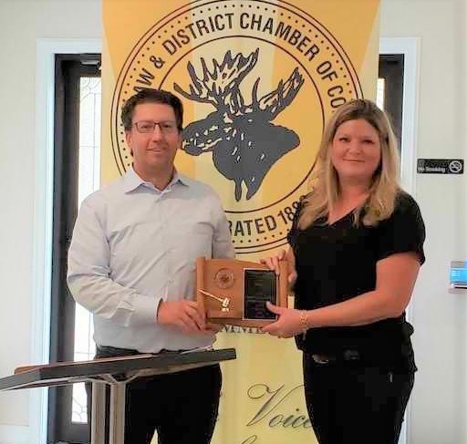 Kylie Sonmor, new president of the chamber of commerce, presents outgoing president Jasmine Cameron with a plaque in appreciation of her time, during the chamber's Sept. 24 AGM. Photo courtesy chamber of commerce