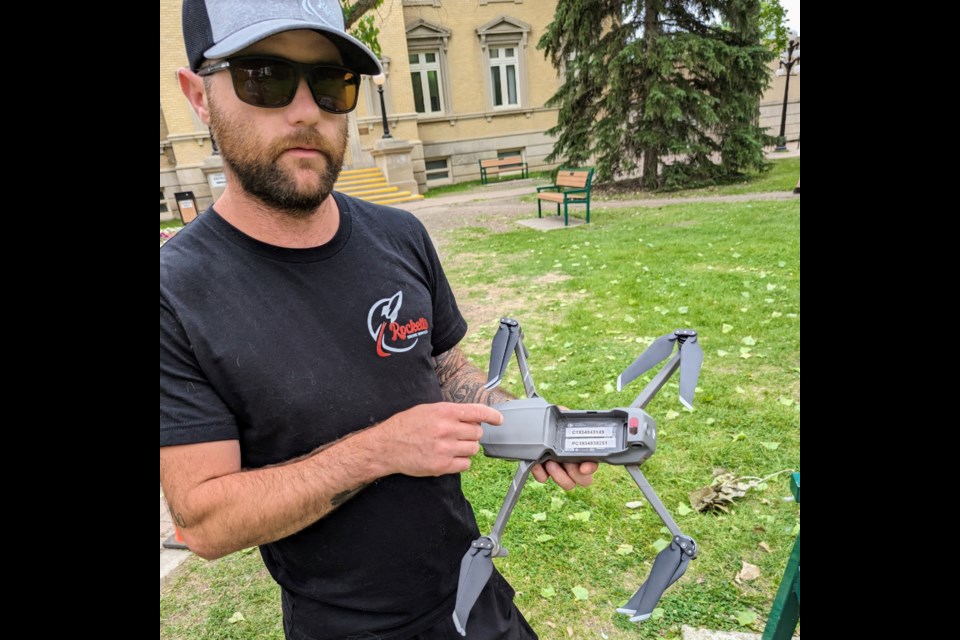 Cody Crockett shows his pilot license number and individual drone registration number on Workhorse, his main drone