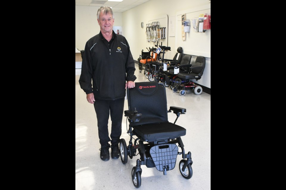 Greg Moore poses with a mobility chair at his business, Motion Mobility and Home Accessibility Products at 319 Main Street North — formerly known as Easy Care Living Centre and Golden Mobility and Rehab Limited. He will soon receive an award in Saskatoon for his work helping the community. Photo by Jason G. Antonio