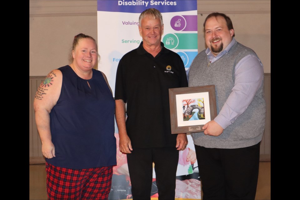 Moose Jaw businessman Greg Moore (centre) receives the 2022-23 Excellence in Action Award from national charity Christian Horizons for his work supporting people with disabilities, during the agency's recent annual meeting in Saskatoon. Photo submitted
