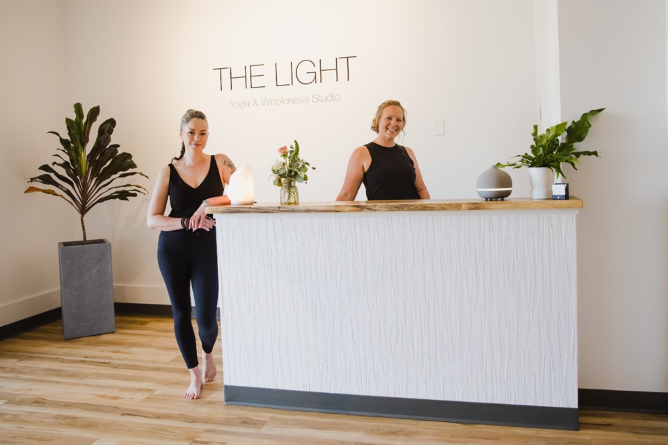 Mei-Ling Chow-Mintenko and Jessie Reid at the front desk of their studio