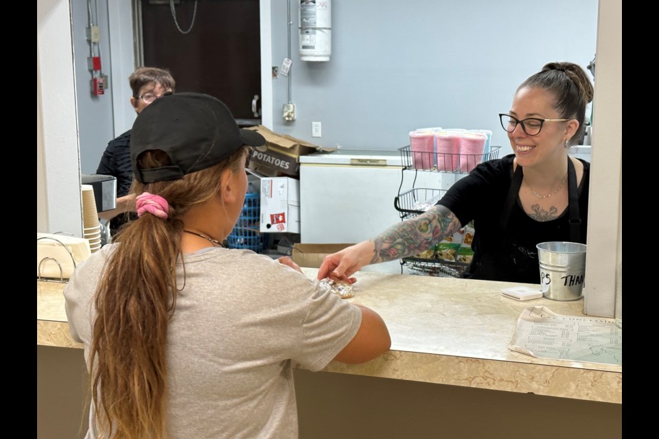 Melina Fulton (right) serves another customer