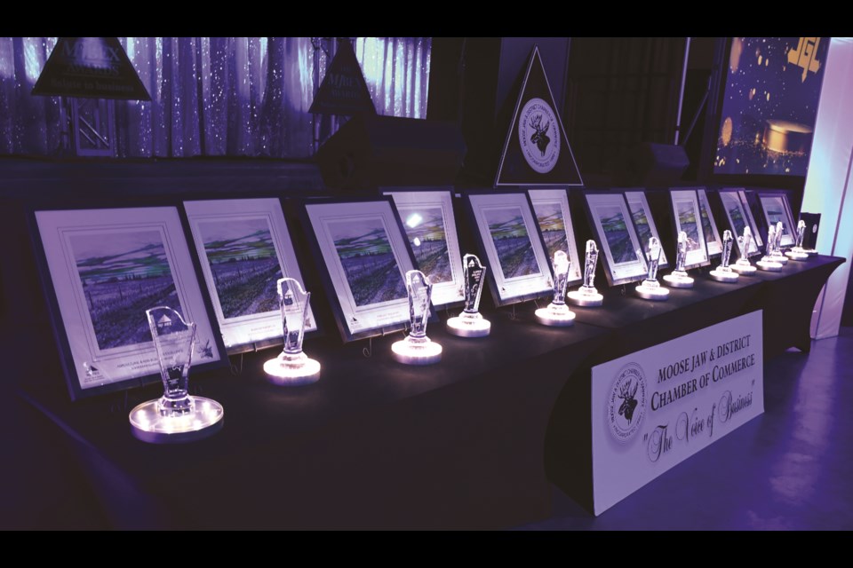 Fourteen trophies and accompanying paintings line a table at the 2025 MJBEX awards banquet at the Temple Gardens Centre. Photo by Jason G. Antonio 