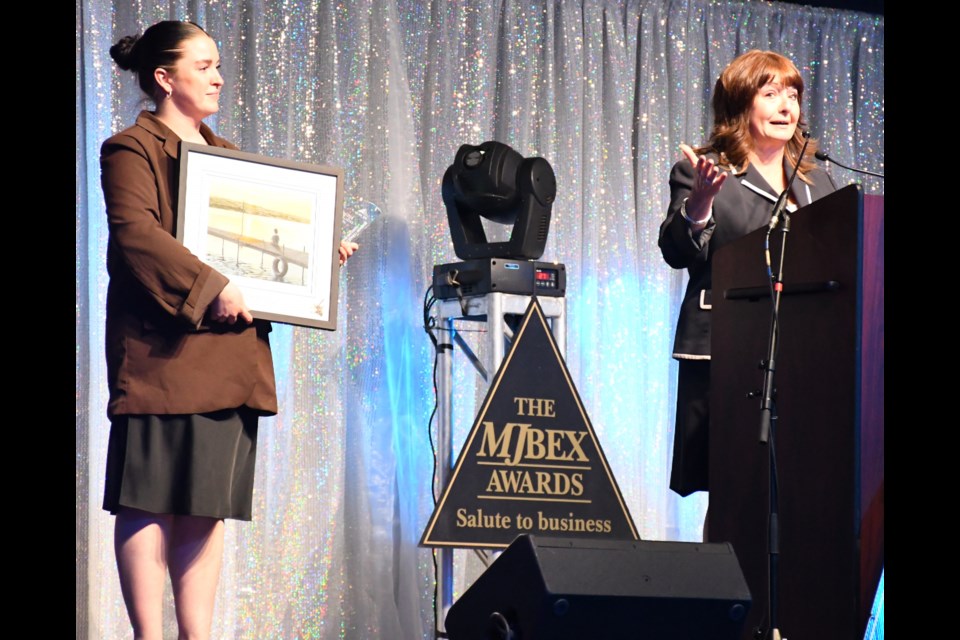Vanessa (Boyczuk) Cowan (right), with her daughter Madisan, accepts the Business Leader of the Year Award on behalf of her deceased mother, Christine Boyczuk. Photo by Jason G. Antonio