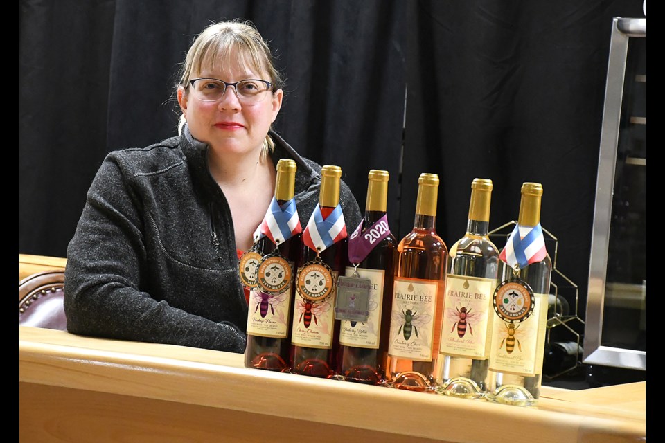 Crystal Milburn with some of Prairie Bee Meadery’s award-winning product in their new Grant Hall location.