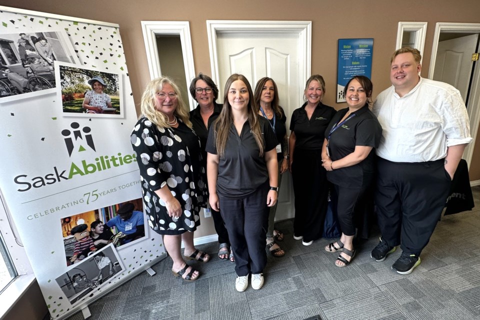 Representatives with Partners in Employment gather for a group photo during the June 11 open house.