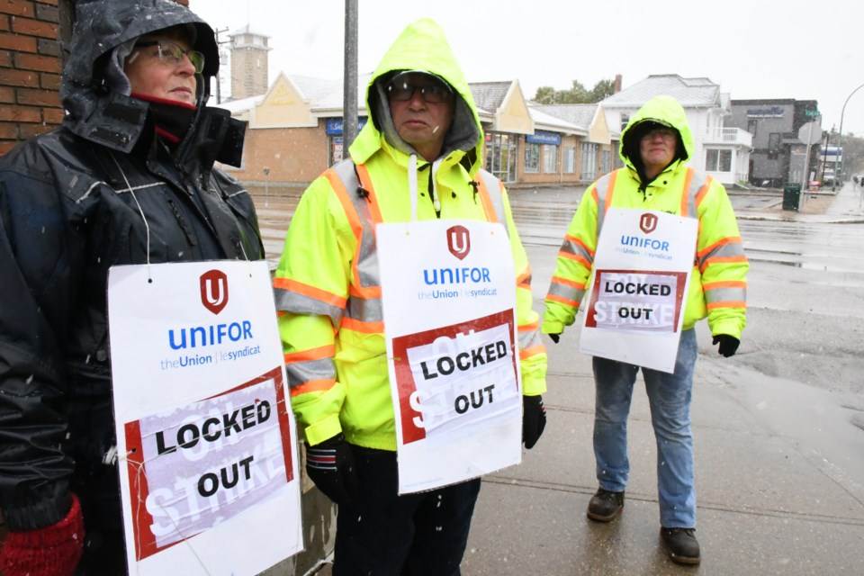 Cathy Charpentier and Alex Meyer, employees of SaskTel and union members with Unifor, walk the streets on Oct. 8 during the fifth day of the union’s strike. Photo by Jason G. Antonio