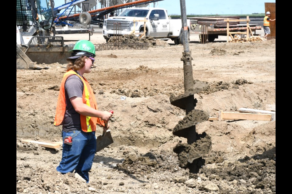 A Bob Nelson Construction employee works on the new lentil processing facility underway at Simpson Seeds on June 26.
