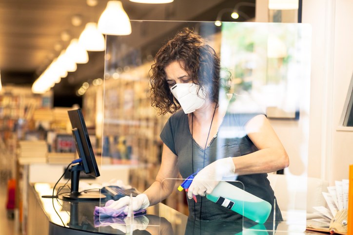 store owner sanitizing